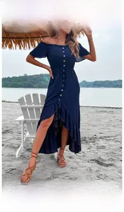 Outdoor beach shot of navy off-shoulder dress with buttons and ruffle hem detail