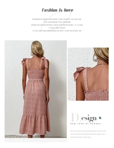 Detail of pink floral summer dress featuring shoulder ties and ruffled tiered hemline