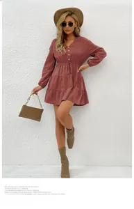 Detail of V-neck long sleeve dress with button-front and tiered skirt in terracotta