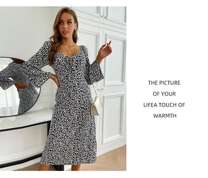 Detail of floral print dress with heart-shaped neckline and puff mid-length sleeves