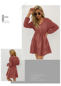 Detail of V-neck tiered mini dress with button front and drawstring waist in rust pink