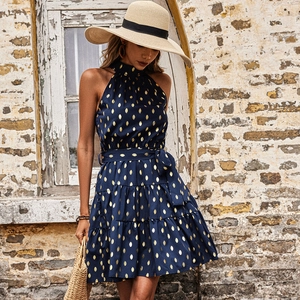 Navy blue halter neck summer dress with gold leaf dots and tiered skirt for beach vacation