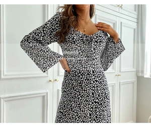 Detail of V-neck tie and bell sleeves on a black floral print midi dress for women