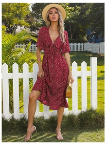 Detailed V-neck of red polka dot dress with elegant bow tie and short butterfly sleeves