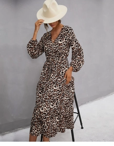 Detailed close-up of leopard print V-neck dress with button-front and ruffled layers
