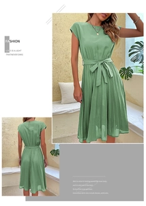 Detail of sage green pleated dress with crew neck, waist tie and elegant chiffon texture
