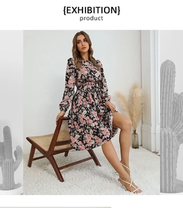 Detail of French vintage floral long sleeve dress featuring pink rose print on black base