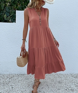 Detail of coral V-neck sleeveless maxi dress with button-up front and layered hemline