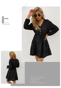 Detail of V-neck black long sleeve dress with waist drawstring and layered ruffle hem