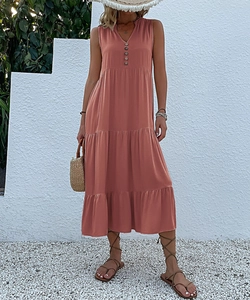 Detail of dusty pink sleeveless V-neck maxi dress with button-front and tiered skirt layers