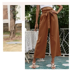 Détail d'un pantalon marron à taille haute et jambe large avec ceinture à nouer élégante