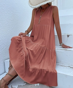 Detail of V-neck long dress in dusty rose with wooden buttons and tiered design