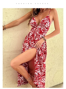 Detail of red floral maxi dress featuring a high slit and deep V-neck for summer vacation