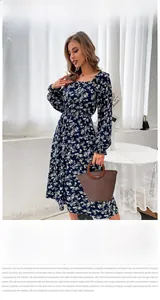 Close-up of vintage navy floral dress featuring a square neckline and white flower pattern