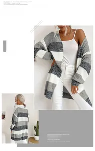 Detail of color-block striped knit cardigan in grey, white, and black with open front