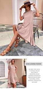 Detailed view of dusty pink tiered maxi dress with puff sleeves and pleated hem layers