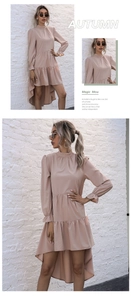 Detail view of pink long sleeve dress with ruffled cuffs and irregular fishtail hemline