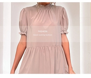 Detail of high neck pleated collar and puff sleeves on light pink loose chiffon dress