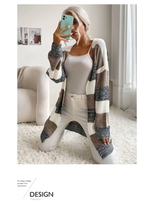 Detail of a women's striped knit cardigan featuring brown, grey and white color-block panels