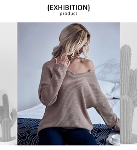 Close-up of khaki waffle knit sweater featuring an elegant V-neck and drop shoulder design