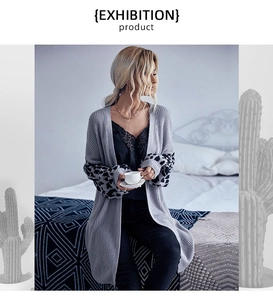 Detail view of knitted long cardigan with leopard print drop shoulder sleeves on model