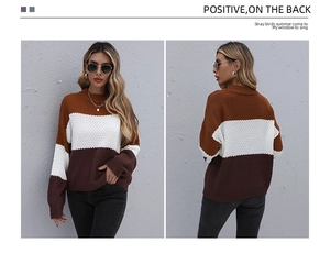 Detailed texture of honeycomb knit fabric on the tricolor color-block sweater