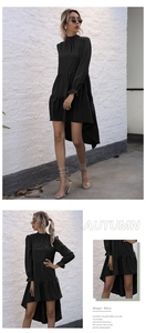Detail of high neck black dress featuring ruffled cuffs and an asymmetric tiered hemline