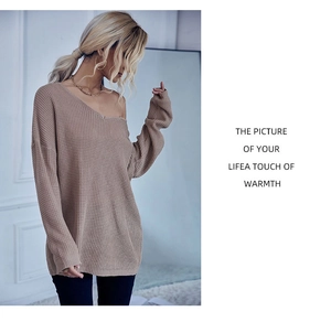Detail of loose oversized waffle knit sweater featuring off-shoulder texture in khaki
