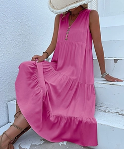 Detail of rose pink V-neck sleeveless tiered dress with decorative wooden buttons