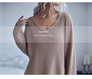 Detail shot of beige waffle knit sweater featuring V-neckline and chunky texture