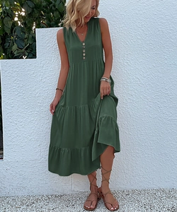 Detail of summer sleeveless V-neck dark green maxi dress with buttons and tiered skirt