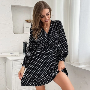 Elegant black wrap dress with white polka dots, V-neck, waist tie and ruffled hem details