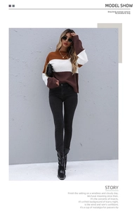 Detailed texture of color-block knit sweater in caramel and white with crew neck