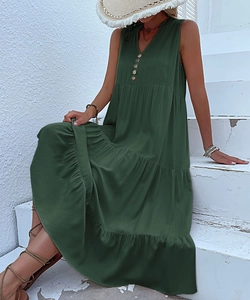 Detail of dark green V-neck dress with wood buttons and layered tiered skirt for summer
