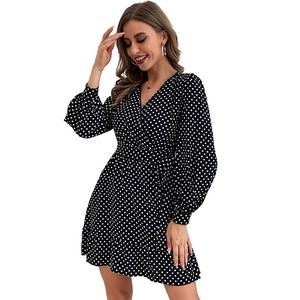 Women's black polka dot V-neck wrap dress with long sleeves and waist tie detail
