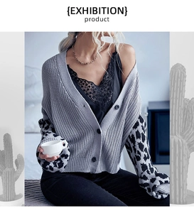 Close-up of leopard print patchwork sleeve on a grey knit cardigan with buttons