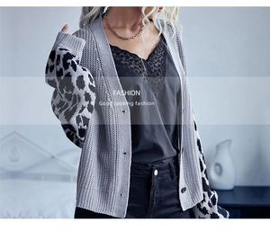 Detail of grey chunky knit cardigan with leopard print patchwork sleeves and lace trim