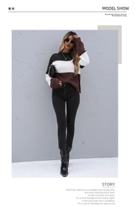 Detail of color-block crewneck sweater with black, white and brown knit textures