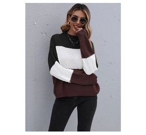 Detail of color-block knit sweater texture with ribbed cuffs in black white and brown