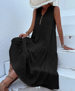 Detail of V-neck sleeveless black maxi dress with decorative wooden buttons and layered hem