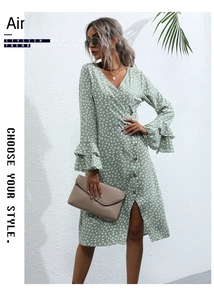 Detail of light green polka dot dress with V-neck, wood buttons and ruffled cuffs
