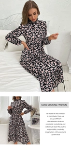 Detail view of floral midi dress with ruffle high neck and long sleeves on black chiffon