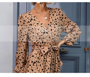 Detailed view of women's leopard print wrap dress featuring deep V-neck and waist tie design