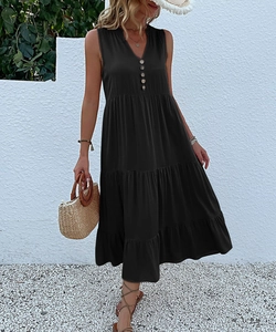 Close-up of black sleeveless V-neck maxi dress with button details and tiered skirt