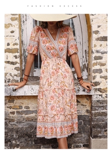 Dettaglio dell'abito midi floreale rosa con scollo a V, maniche a sbuffo e gonna boho