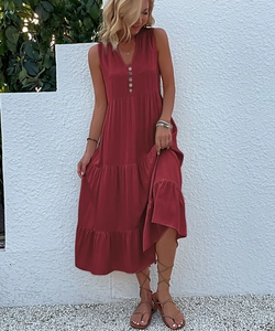Detail of burgundy V-neck tiered maxi dress with decorative buttons and sleeveless cut