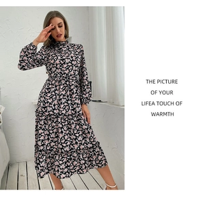 Detailed close-up of floral print long sleeve midi dress with mock neck and tiered hem