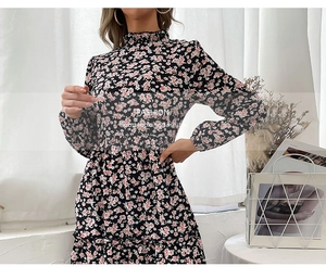 Detail of high neck ruffle floral dress with pleated hem in soft chiffon fabric