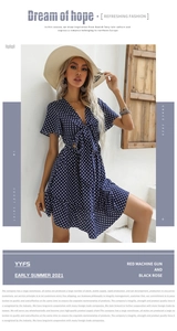 Detail of V-neck tie-front design on navy blue polka dot short sleeve french dress