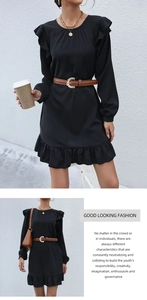 Detail of black ruffled long sleeve dress with a slim brown belt and metal buckle